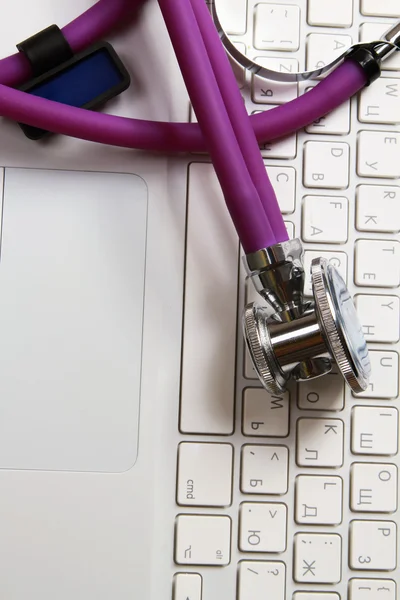 Stethoscope over laptop keyboard. — Stock Photo, Image