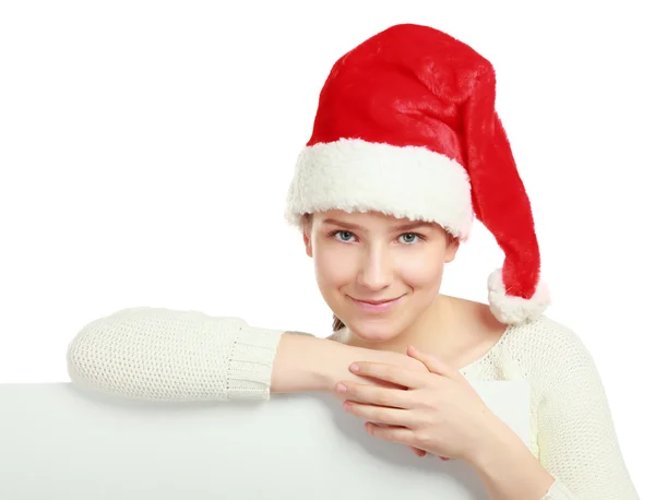 Üres tábla közelében santa kalap a karácsonyi gyönyörű nő. — Stock Fotó