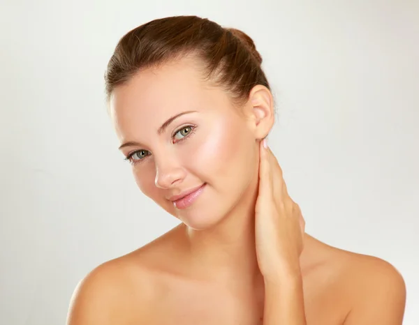 A beautiful young woman touching her face — Stock Photo, Image