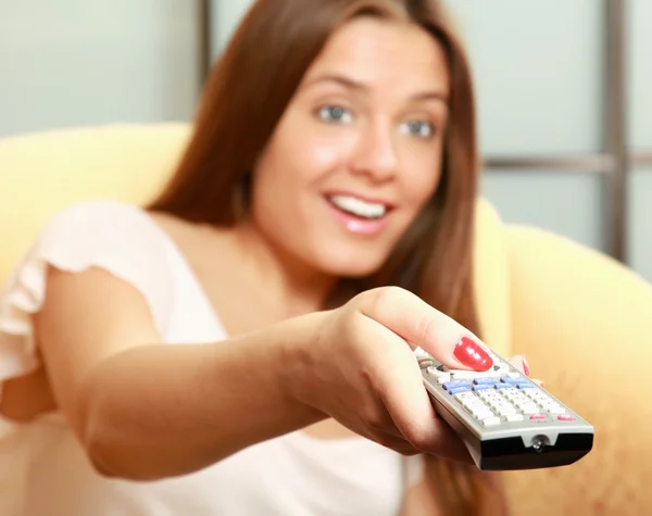 Woman   holding remote control panel TV — Stock Photo, Image