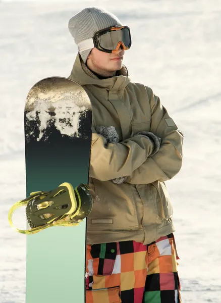 Snowboarder standing near board. — Stock Photo, Image