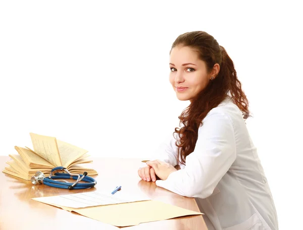 Female doctor sitting on the desk — Stock Photo, Image