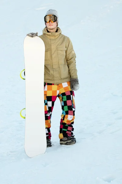 Snowboarder standing near board. — Stock Photo, Image