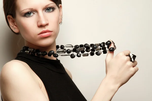 Woman is holding a beads — Stock Photo, Image