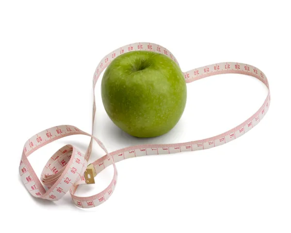 A green apple and a measurement tape — Stock Photo, Image