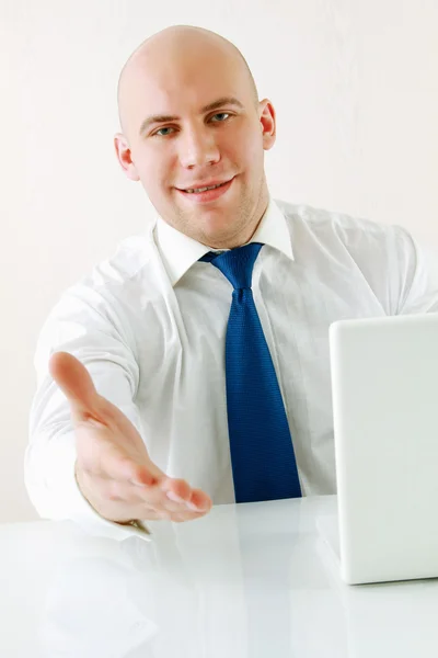 A young businessman giving his hand Stock Picture