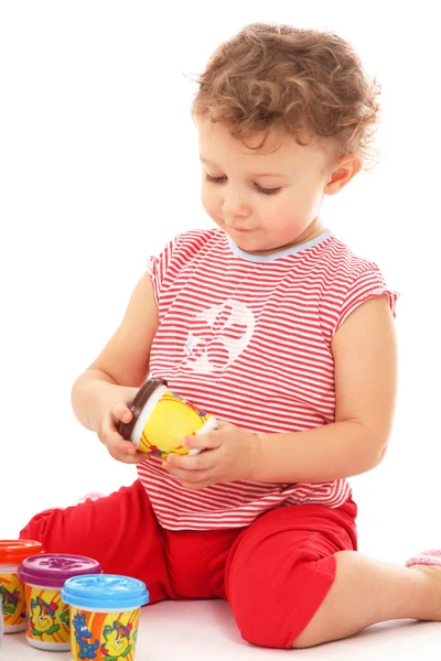 Child sitting floor with jar of paint — Stock Photo, Image