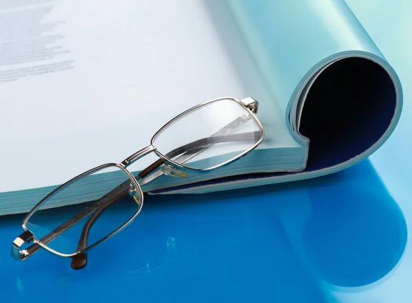 Brille auf einem Buch liegend — Stockfoto