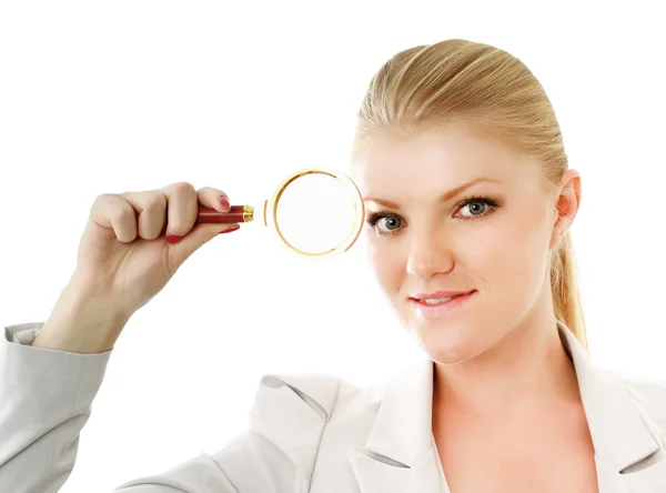 Businesswoman looking into a magnifying glass — Stock Photo, Image