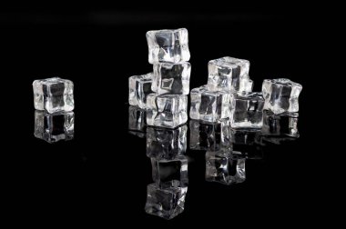 Ice cubes reflected in black glass. Concept of ice shortage