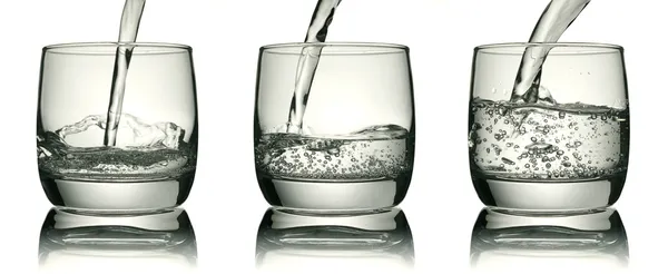 Three glasses with a water jet — Stock Photo, Image