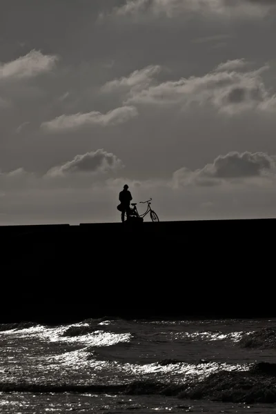 Persoon naast zijn of haar fiets op de pier — Stockfoto