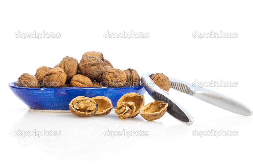 Walnuts and nutcracker on isolated background