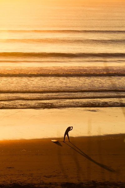 Surfeurs sur la plage au coucher du soleil — Photo