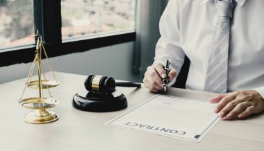 Businessman hand sign contract after lawyer providing legal consult dispute.
