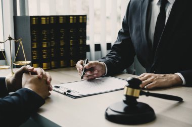 Lawyer hand holding pen and providing legal consult business dispute to the man.