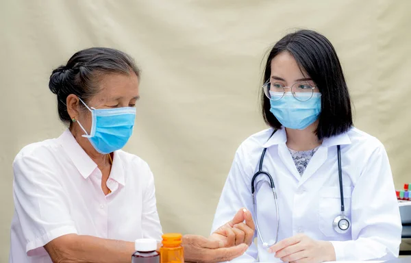 Woman doctors report health examination results and recommend medication and guides friendly health care to elderly patients.