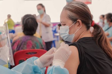 doctor hand, Fat Asia senior woman has gone to vaccinate coronavirus covid19 with medical staff in a field hospitel. a place set up by the government.