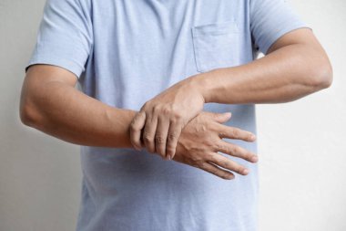 Man hand massage physiotherapy wrist is sore and numb, exhausted, tingling. Guillain-Barre Syndrome, a side effect of the Covid vaccination.