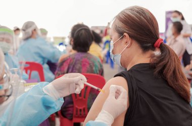 Fat Asia senior woman has gone to vaccinate coronavirus covid19 with medical staff in a field hospitel. a place set up by the government.