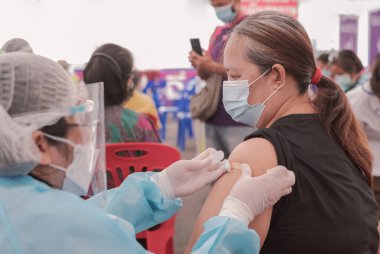 Fat Asia senior woman has gone to vaccinate coronavirus covid19 with medical staff in a field hospitel. a place set up by the government.