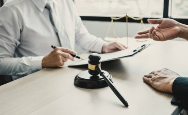 gavel hammer standing in front of the lawyer providing legal consult business dispute service at the office with justice scale.