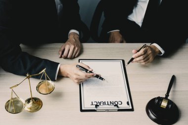 Lawyer hand holding pen and providing legal consult business dispute to the man.