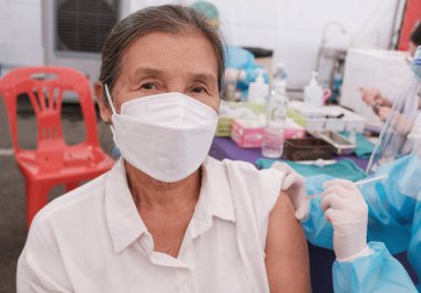 Asia senior woman has gone to vaccinate coronavirus covid19 with medical staff in a field hospitel. a place set up by the government.