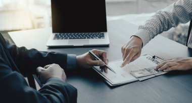 Government officials hand sign the contract for receiving bribe money from businessman, the concept of corruption and anti-bribery.
