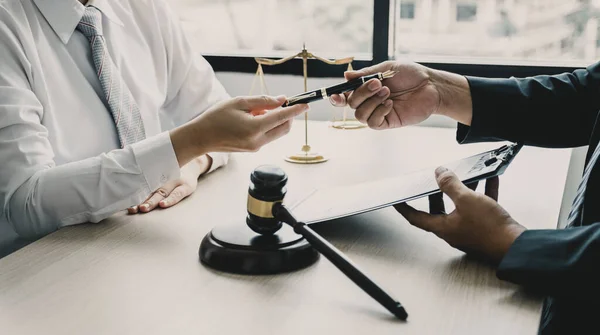 Lawyer hand holding pen and providing legal consult business dispute to the man.