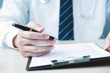 The doctor hand holding and pointing report, explained the health examination results to the patient, medical checkup concept.