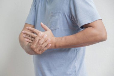 Fat Asia Man hand massage physiotherapy other side is sore and numb, exhausted, tingling. Guillain-Barre Syndrome, a side effect of the Covid-19 vaccination.