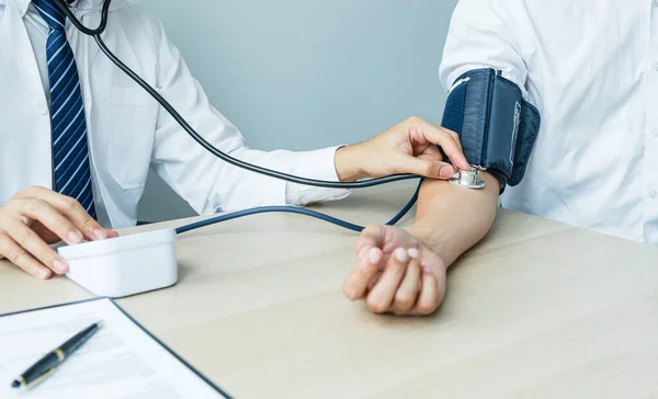 Doctor Evaluates Patient Stethoscope Blood Pressure Monitor Records Results Health — Foto de Stock