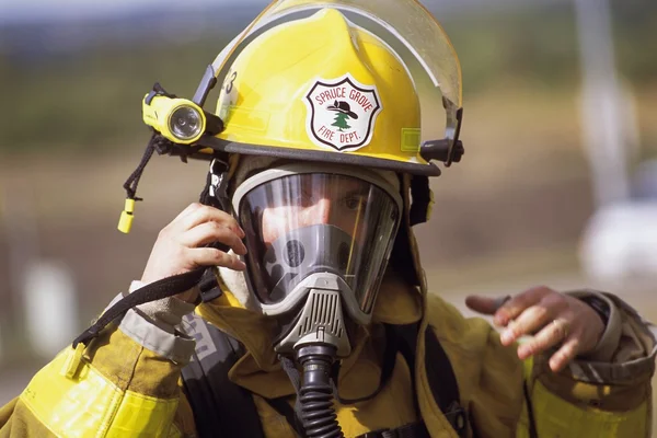 Feuerwehrmann passt Maske an — Stockfoto