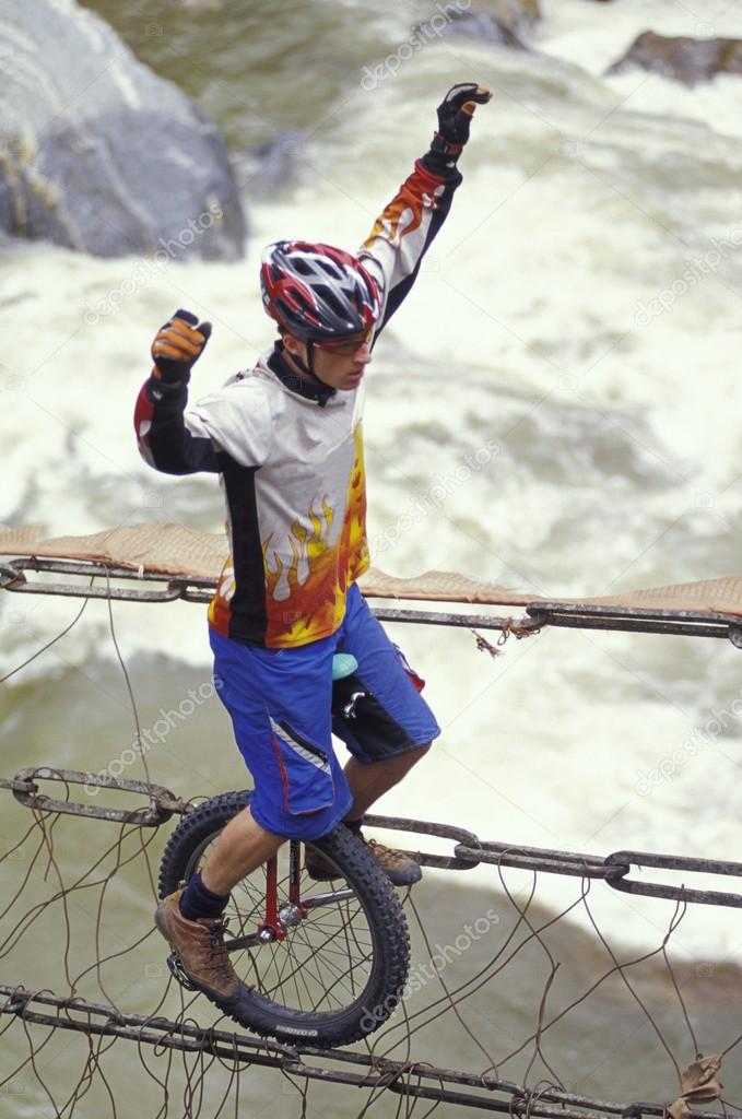 Unicyclist Crossing River On Unicycle