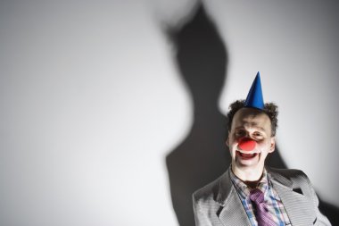 Man Wearing A Clown's Nose And Hat clipart