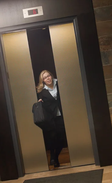 Late for Work-Getting Off Elevator — стоковое фото