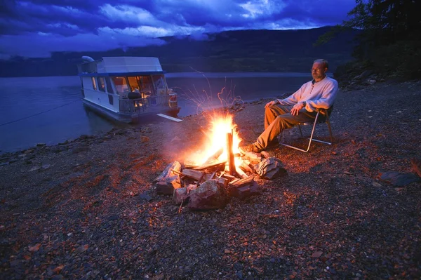 Mann an Land entspannt am Lagerfeuer — Stockfoto