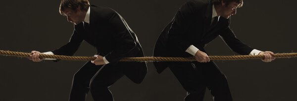 Two Men Pulling In Opposite Directions On A Rope