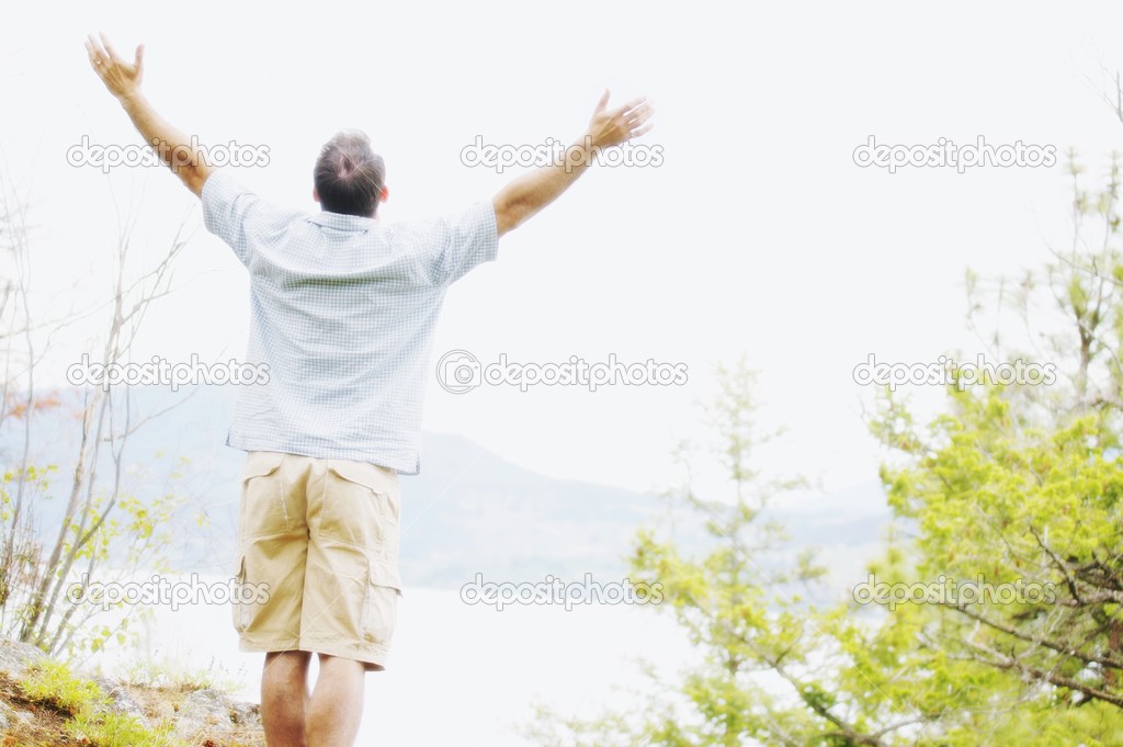 A Man Lifts His Hands Towards Heaven