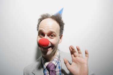 Man Wearing A Clown's Nose And Hat clipart