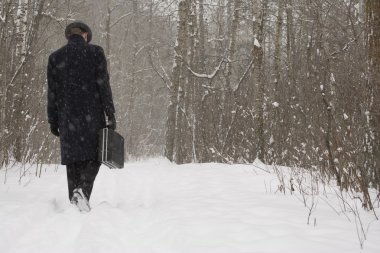 Businessman Walking Through The Snow clipart