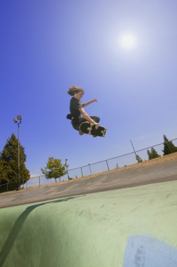 A Skateboarder Does A Trick clipart