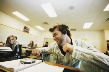 Student Listening To Music At Desk clipart