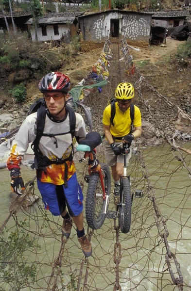 Unicyclists Cruzando um rio — Fotografia de Stock