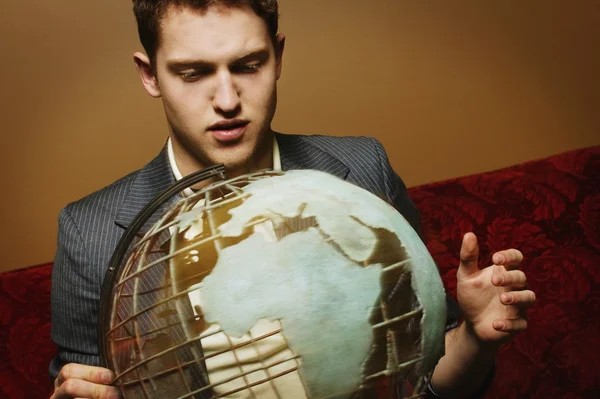 Businessman Looking At A Globe — Stock Photo, Image