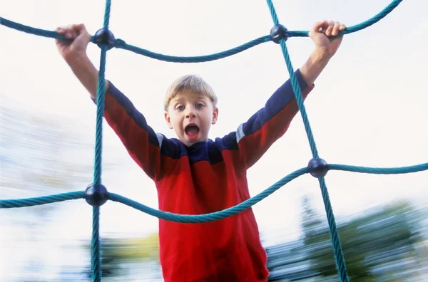 Rapaz no parque infantil passeio — Fotografia de Stock