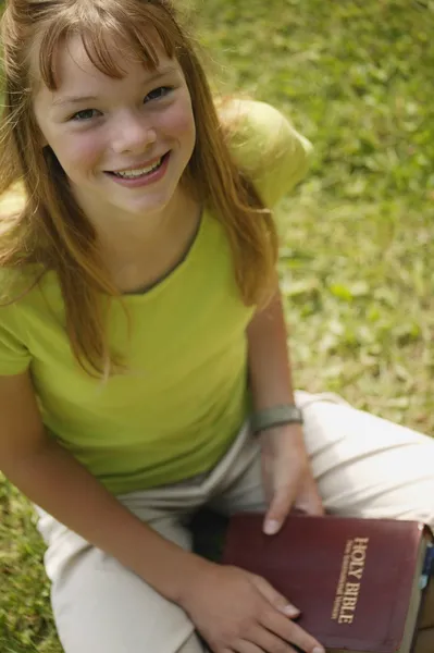 Une fille tient une Bible — Photo