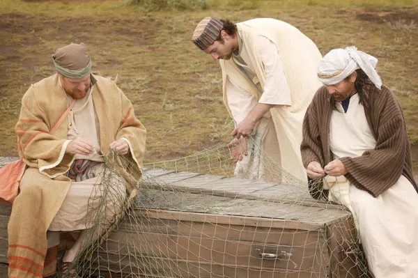 Three Men Working On A Fishing Net — Stock Image Three Men Working On A Fishing Net Royalty Free Stock Images