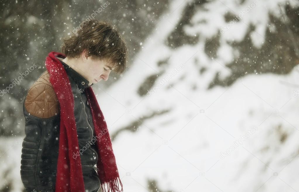 Young Man Standing As It Snows